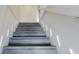 Stairs feature white risers and stringers paired with stained treads, providing a contemporary look at 4752 S Atlantic Ave # 1, Ponce Inlet, FL 32127