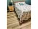 Inviting bedroom featuring wood-look flooring, a nightstand and a bed with decorative bedding at 5300 S Atlantic Ave # 3-405, New Smyrna Beach, FL 32169