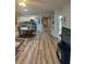 Spacious living area featuring wood-look floors, dining area and kitchen at 5300 S Atlantic Ave # 3-405, New Smyrna Beach, FL 32169