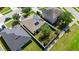 Aerial view of the home's fenced backyard with solar panels on the roof at 5304 Cordgrass Bend Ln, Port Orange, FL 32128