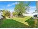 This backyard has a well-maintained lawn, beautiful landscaping, and a privacy fence all around at 5304 Cordgrass Bend Ln, Port Orange, FL 32128