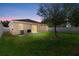 Spacious backyard with a lush lawn, privacy fence, and sliding glass doors to the home at 5304 Cordgrass Bend Ln, Port Orange, FL 32128