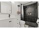 Stylish bathroom featuring a black tiled shower, modern vanity, and sleek fixtures at 5304 Cordgrass Bend Ln, Port Orange, FL 32128