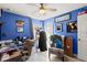 Comfortable bedroom featuring blue walls, a desk and chair, and plenty of room at 5304 Cordgrass Bend Ln, Port Orange, FL 32128