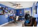 Inviting bedroom with a work desk, a ceiling fan, and blue walls at 5304 Cordgrass Bend Ln, Port Orange, FL 32128
