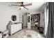 Bright bedroom with organized closet space, natural light, and a ceiling fan at 5304 Cordgrass Bend Ln, Port Orange, FL 32128