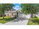 Charming one-story home with a well-maintained lawn, beautiful landscaping, and a two-car garage at 5304 Cordgrass Bend Ln, Port Orange, FL 32128