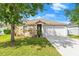 Charming one-story home featuring a well-maintained lawn, beautiful landscaping, and a two-car garage at 5304 Cordgrass Bend Ln, Port Orange, FL 32128