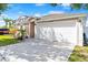 Exterior elevation of a charming home featuring an attached two-car garage and front yard landscaping at 5304 Cordgrass Bend Ln, Port Orange, FL 32128