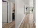 Bright hallway featuring wood floors, leading to bedrooms and the living area at 5304 Cordgrass Bend Ln, Port Orange, FL 32128