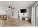 Spacious living room with wood flooring, fireplace, and modern ceiling fan at 5304 Cordgrass Bend Ln, Port Orange, FL 32128
