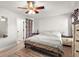 Comfortable main bedroom featuring a ceiling fan, neutral decor, and access to bathroom at 5304 Cordgrass Bend Ln, Port Orange, FL 32128