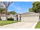 Charming one-story home featuring a spacious garage, lush landscaping, and a well-maintained lawn at 6068 Spruce Point Cir, Port Orange, FL 32128