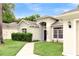 Well-maintained home with lush lawn and landscape, an arched entryway and large windows at 6068 Spruce Point Cir, Port Orange, FL 32128