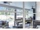 Cozy covered porch area with wicker furniture, a dining table, and a view of the pool at 6068 Spruce Point Cir, Port Orange, FL 32128