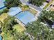 Aerial view of a home with a metal roof, a patio with outdoor seating, and surrounding green spaces at 650 S Pine St, New Smyrna Beach, FL 32169