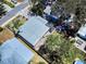 An aerial view of a home showing its roof, backyard with patio, and surrounding trees at 650 S Pine St, New Smyrna Beach, FL 32169