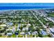 Aerial view of a neighborhood stretching towards the coast with ocean views and lush greenery at 650 S Pine St, New Smyrna Beach, FL 32169