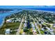 Picturesque aerial view of a coastal community with waterway access, bridges, and a mix of housing types at 650 S Pine St, New Smyrna Beach, FL 32169