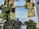 Aerial view of a home with a metal roof, featuring an open backyard and lush trees at 650 S Pine St, New Smyrna Beach, FL 32169