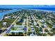 High aerial view of a coastal community with waterway access, bridges, and a mix of housing and mature trees at 650 S Pine St, New Smyrna Beach, FL 32169