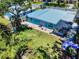 This home boasts a metal roof, a brick patio with seating, and large manicured lawn and landscaping at 650 S Pine St, New Smyrna Beach, FL 32169