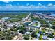 Aerial view of a coastal community with a bridge, waterways, and lush green surroundings at 650 S Pine St, New Smyrna Beach, FL 32169