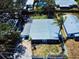 Overhead perspective displays home's location, mature landscaping, metal roof, and lot within the community at 650 S Pine St, New Smyrna Beach, FL 32169