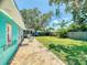 Spacious backyard with a brick patio, a well-maintained lawn, and ample space for entertaining guests at 650 S Pine St, New Smyrna Beach, FL 32169
