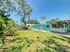 Large backyard with mature trees, lush landscaping, outdoor bar, and a shed at 650 S Pine St, New Smyrna Beach, FL 32169