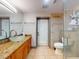 Bathroom featuring granite counters, bowl sink, tile floors, and glass shower enclosure at 650 S Pine St, New Smyrna Beach, FL 32169