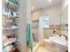 Bathroom featuring stylish tile surround, basin sink, toilet, and shower combo with shower curtain at 650 S Pine St, New Smyrna Beach, FL 32169