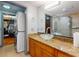 Bathroom with a glass bowl sink, granite countertops, walk-in shower and closet with a stacked washer and dryer at 650 S Pine St, New Smyrna Beach, FL 32169
