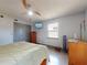 Bedroom featuring closet, access door, light color walls, tile floor, and a modern ceiling fan at 650 S Pine St, New Smyrna Beach, FL 32169