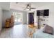 Bright bedroom featuring wood-look tile floors and large sliding glass doors at 650 S Pine St, New Smyrna Beach, FL 32169