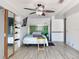 Bright bedroom with tile floors, a ceiling fan, and a mounted TV at 650 S Pine St, New Smyrna Beach, FL 32169