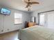 Bedroom featuring closet, access door, light color walls, tile floor, and a modern ceiling fan at 650 S Pine St, New Smyrna Beach, FL 32169