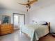 Bedroom featuring closet, access door, light color walls, tile floor, and a modern ceiling fan at 650 S Pine St, New Smyrna Beach, FL 32169