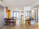 Spacious dining area with a rustic wooden table, terrazzo floors and views of the outdoors at 650 S Pine St, New Smyrna Beach, FL 32169