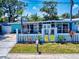 Charming home featuring a white picket fence, well-manicured lawn, and light blue exterior at 650 S Pine St, New Smyrna Beach, FL 32169