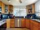 Bright kitchen with stainless steel appliances, granite counters, and ample cabinet space at 650 S Pine St, New Smyrna Beach, FL 32169