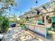 Outdoor bar area featuring a custom bar, seating, lighting, and a covered roof for entertaining at 650 S Pine St, New Smyrna Beach, FL 32169