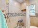 Shower featuring stylish pebble tile surround, built in seat, and rain style shower head at 650 S Pine St, New Smyrna Beach, FL 32169