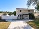 Two-story home featuring a long driveway, fenced yard, and well-kept landscaping at 653 Sweetwood Dr, Port Orange, FL 32127