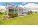 The backyard boasts a screened-in pool, green lawn, and tasteful landscaping at 6808 Forkmead Ln, Port Orange, FL 32128