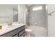 Modern bathroom featuring a tiled shower/tub combo, a sink with a dark cabinet, and granite counters at 6808 Forkmead Ln, Port Orange, FL 32128