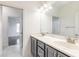 Bathroom featuring double sinks, ample vanity space, and modern lighting at 6808 Forkmead Ln, Port Orange, FL 32128