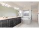Bathroom with double vanity, soaking tub, tiled shower, and plenty of natural light at 6808 Forkmead Ln, Port Orange, FL 32128
