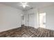 Spacious bedroom with a ceiling fan, wood floors, and access to an adjacent room at 6808 Forkmead Ln, Port Orange, FL 32128
