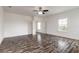 Spacious bedroom with ceiling fan, neutral paint, and wood-look flooring at 6808 Forkmead Ln, Port Orange, FL 32128